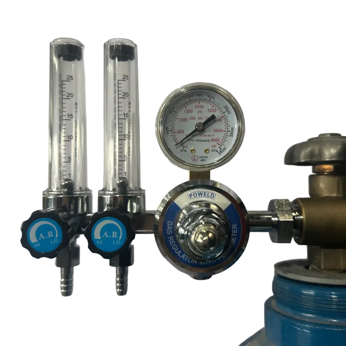 An oxygen regulator setup with two clear flow meters, a round analog pressure gauge, and blue adjustment knobs, attached to a blue gas cylinder against a plain white background.